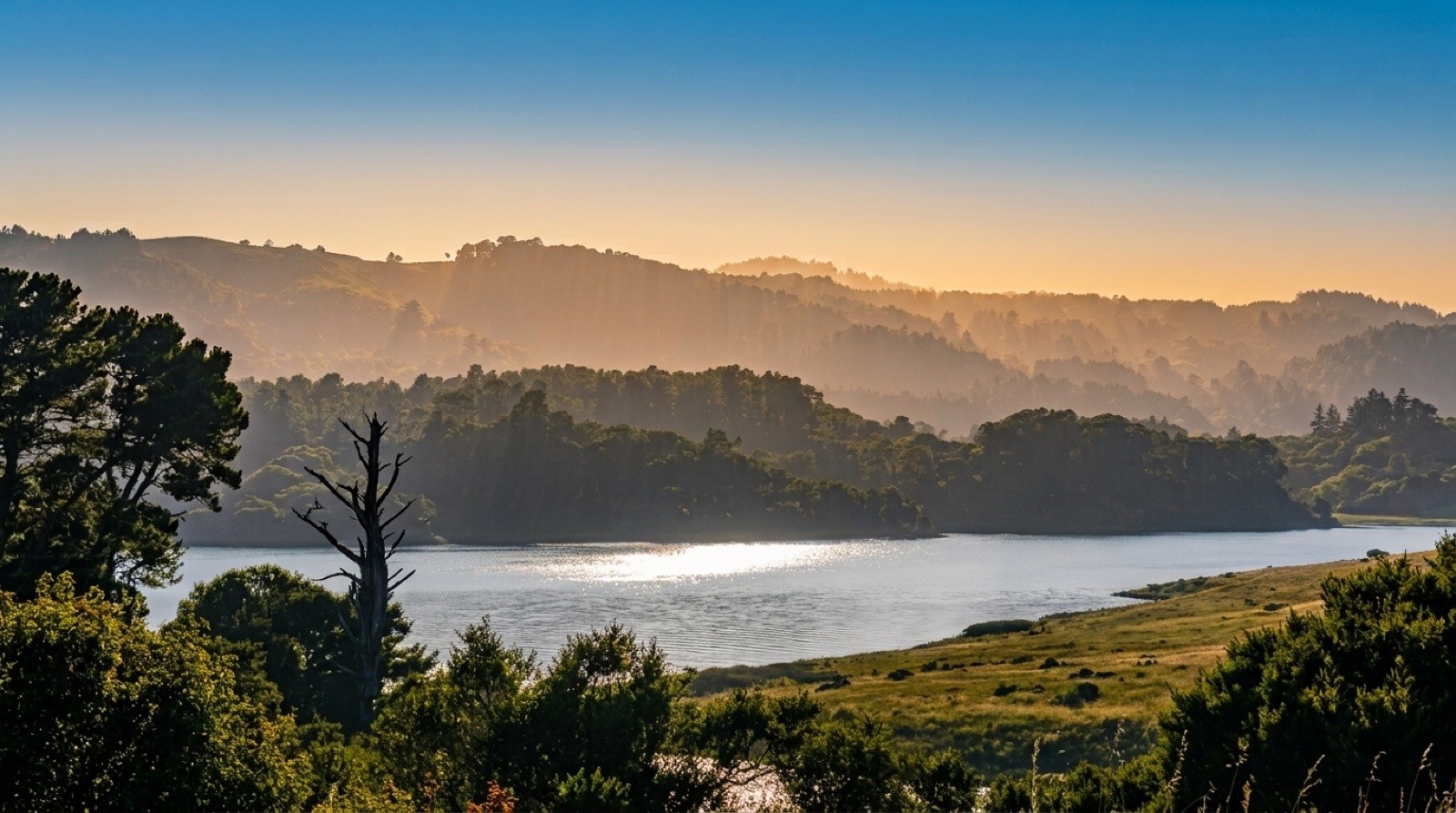 A reservoir at golden hour, ringed by California hills